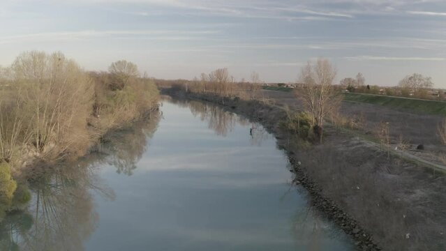 Tracking forward shot on a calm river in Italy at sunset