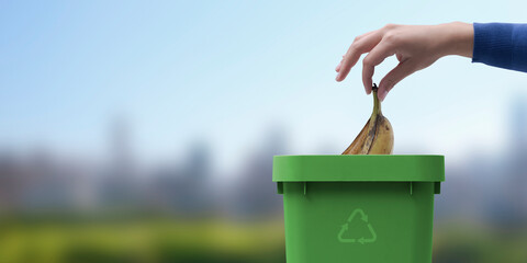 Woman putting organic waste in a bin
