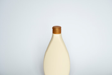 Beige blank plastic bottles isolated on white background.