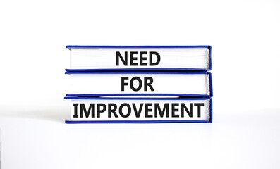 Need for improvement and support symbol. Concept words Need for improvement on books. Beautiful white table white background. Business and need for improvement quote concept. Copy space.