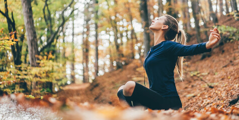 Woman doing yoga pose in peaceful natural forest. Lifestyle and Meditation concept.