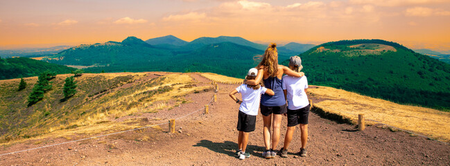 hiker family looking at beautiful view of Auvergne landscape- France,  puy de dome