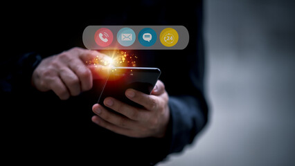 Contact us or the connected customer support hotline. Businessman using laptop and tapping contact icon on virtual screen, phone, email, address, live chat, internet, available 24 hours a day.