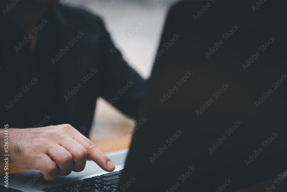 Poster closeup image of a business man's hands working and typing on laptop computer keyboard on office tab