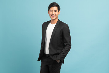 Good looking businessman portrait isolated on blue background