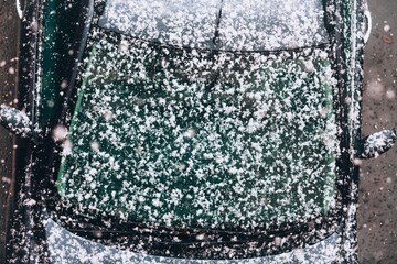 Snow, snowfall, abstract snowflakes fall from above on the car