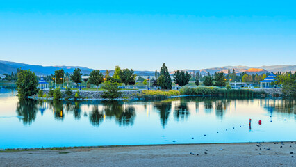 Sparks Marina Park in late summer during blue hour with birds in the water, a clear blue sky and...
