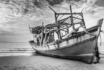 Fishing boat on the beach. Old Boat and the Sea. Black and white scenery. 