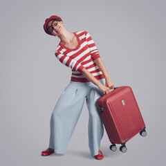 Woman carrying a heavy suitcase