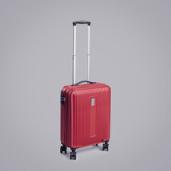 Red rolling suitcase on gray background