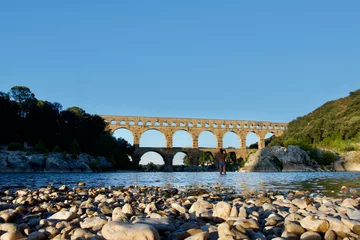 Papier Peint photo Pont du Gard The Magnificent roman "Pont du Gard" bridge and aqueduct at sunset in summer in the south of France. 
