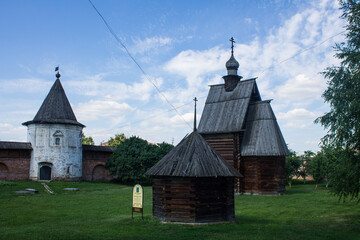 The courtyard of the Kremlin in Yuriev-Polsky in Russia with ancient architecture on bright green...