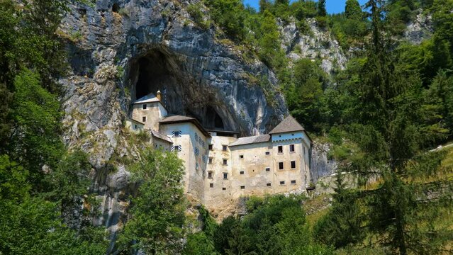 Predjama Castle in Slovenia. Medieval cave castle perched in high cliff with network of secret tunnels, zoom out.