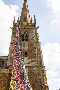 North tower of All Saints church in Middleton Cheney decorated with crochet flower and animals