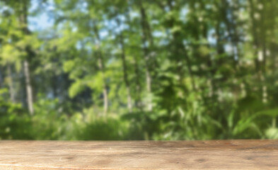 Wooden podium table with bokeh greenery background. The front showcase with a stage for products. A pedestal for the presentation of goods.