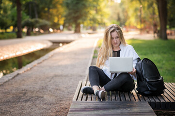 Woman online work outside. Laptop, computer business technology. Student girl working on tablet in summer nature park. People person outdoor. Escaped of office distance education concept