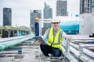 A team of engineers is checking the air conditioning cooling system of a major building or...