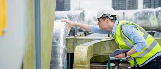 An industry engineer is inspecting the industry cooling tower air conditioner of a huge industrial...