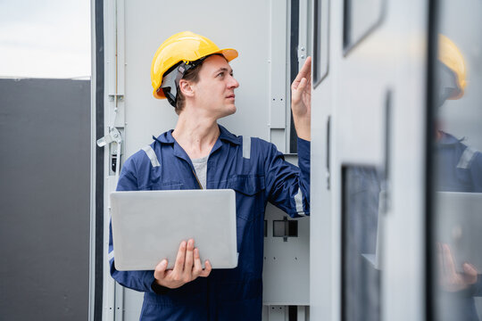 A team of engineers examined the electrical switchboard while checking the operational voltage range.