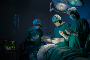 Group of mixed-races professional surgeons operating in hospital operating room , health care concept.