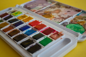 A colorful watercolor palette used for painting