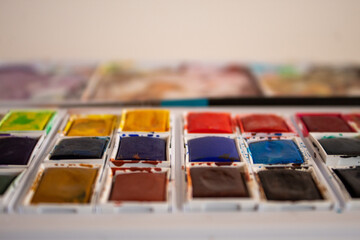 A colorful watercolor palette used for painting