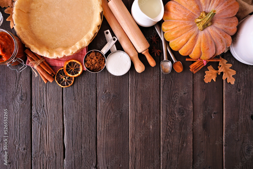 Aufkleber fall baking top border with pumpkin pie ingredients. above view over a dark rustic wood background w
