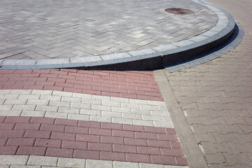 Pedestrian crossing, stone paving from the pavement