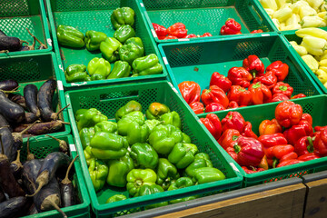 fresh bell peppers a showcase in the vegetable department of a supermarket