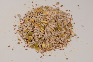 Mix of seeds for a salad. A pile of mixed seeds isolated on white background.