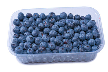 Blueberries in a plastic container isolated on white background.