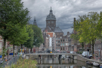 Canal and Cathedral in Amsterdam Before Rain