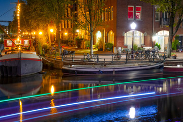 Night Amsterdam Embankment with Houseboats and Bicycles