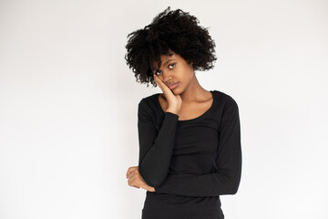 Portrait of bored African American woman looking at camera. Sad young girl wearing black dress standing and looking at camera. Depression concept