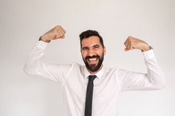 Cheerful bearded man in studio. Male in shirt and tie gesturing and smiling happily. Portrait, emotion, achievement concept
