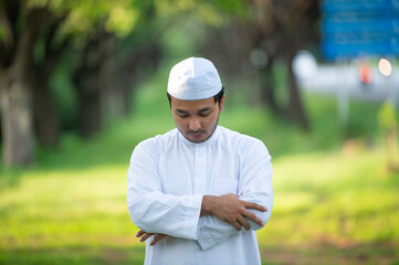 Naklejka na ściany i meble Asian islam man prayer,Young Muslim praying,Ramadan festival concept
