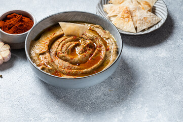 Traditional arabian eggplant dip baba ganoush with herbs and smoked paprika on light background. Eggplant hummus. Babaganush or eggplant caviar. Baked eggplant. Turkish eggplant dip