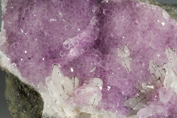 A sample of a natural mineral Amethyst (oxide sclass) a brush of crystals with calcite and pyrite...