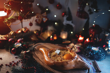 traditional georgian adjarian khachapuri with suluguni cheese, egg yolk, butter