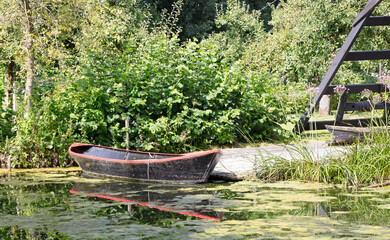 Old wooden rowing boat floating