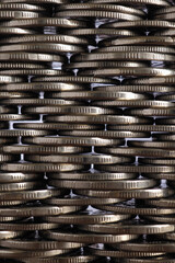 Money wall. Chaotic pile of coins closeup. Nickel coin texture. Vertical business background made of many coin edges. Economy finance and bank wallpaper. Tax and credit. Macro