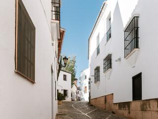 Fototapeta na wymiar Beautiful street with white houses in the center of Ronda, Andalusia, Spain