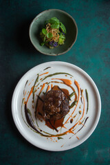 Fine dinnind meat dish with salad