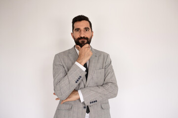 Portrait of attentive bearded man. Male model in suit against white background, thinking. Portrait, studio shot concept