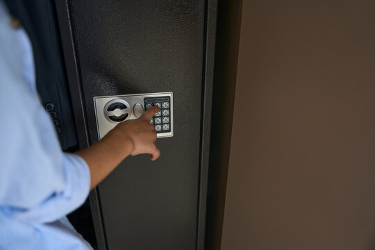 Boy Presses The Buttons On The Gun Safe