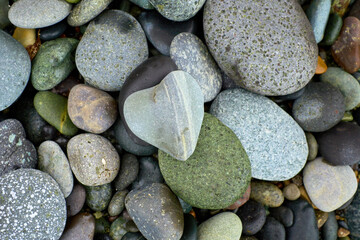 Pebble beach stones background, natural large rounded gravel on the seashore nature background