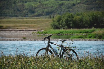 Fototapeta premium Bicycle standing at water stream outdoors in a park