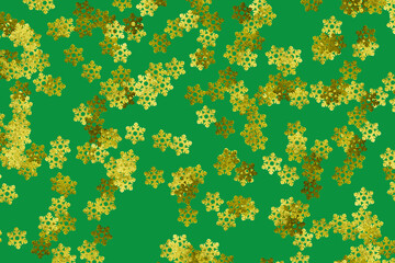 Green background pattern with random gold snowflakes