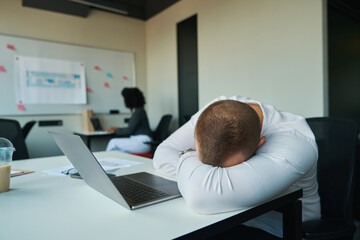 Man fell asleep at his desk in the office