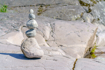 Pyramid of stones. Unstable balance of stone objects. Idyllic state of nature.